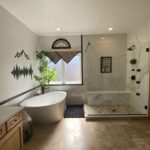 Custom tiled shower with body jets and modern fixtures by Eckert Renovations