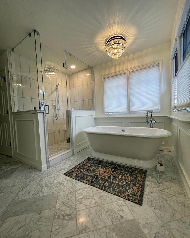 Custom bathroom remodel with marble tile, freestanding tub, and heated floors by Eckert Renovations in Westminster Colorado
