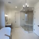 Custom bathroom remodel in Broomfield CO featuring tiled shower, modern lighting, and high-end finishes