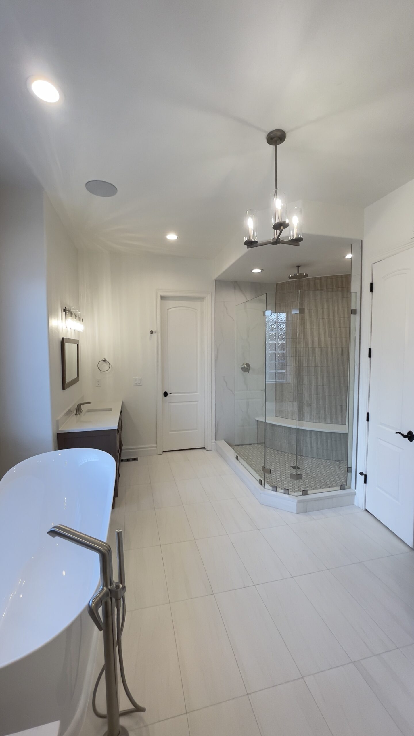 Custom bathroom remodel in Broomfield CO featuring tiled shower, modern lighting, and high-end finishes