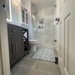 Marble tile bathroom remodel in Thornton CO featuring custom shower, freestanding tub, and modern finishes