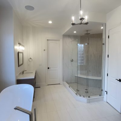 Custom bathroom remodel in Broomfield CO featuring tiled shower, modern lighting, and high-end finishes