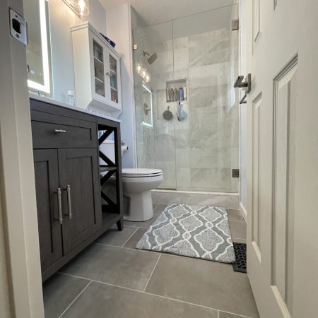 Marble tile bathroom remodel in Thornton CO featuring custom shower, freestanding tub, and modern finishes